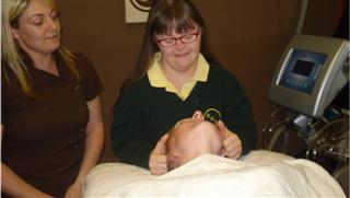 Student washing clients hair